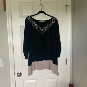 Color block tunic with metal detail at v-neck.